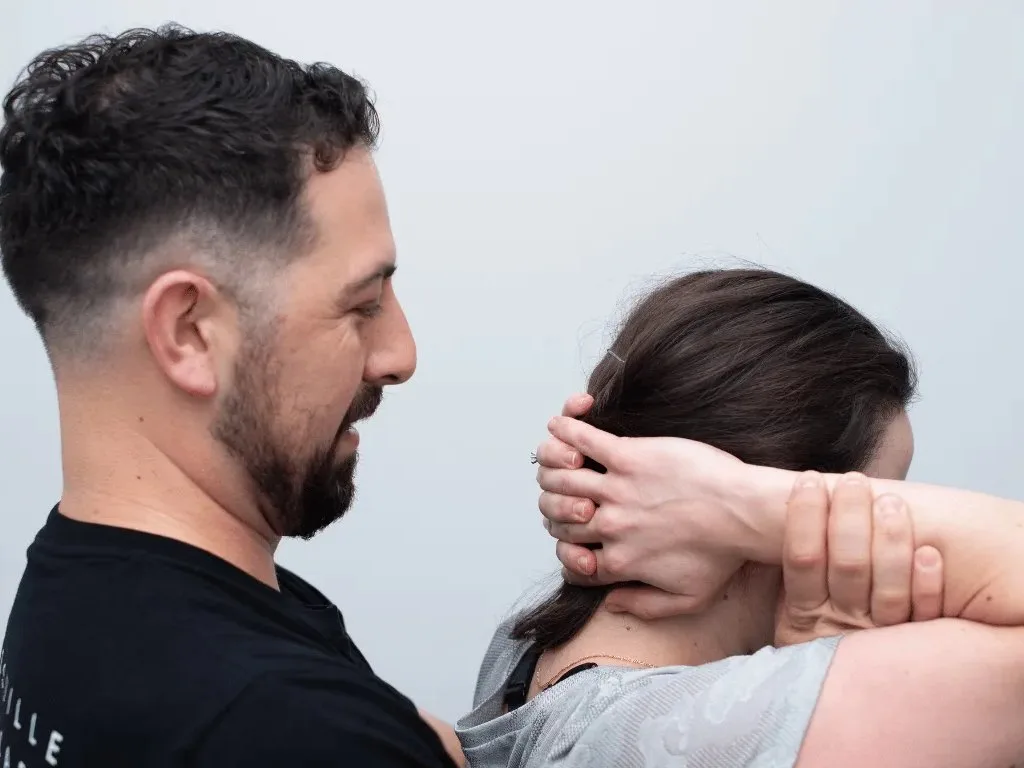 Practitioner treating a patient during a hands-on session