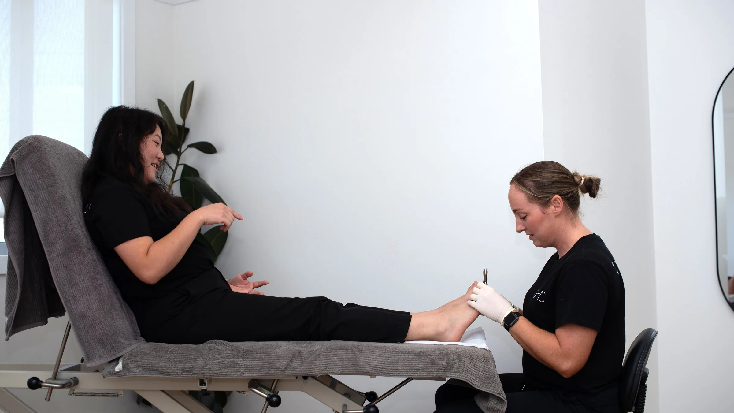 Practitioner treating a patient in a treatment room at Gladesville Healthcare