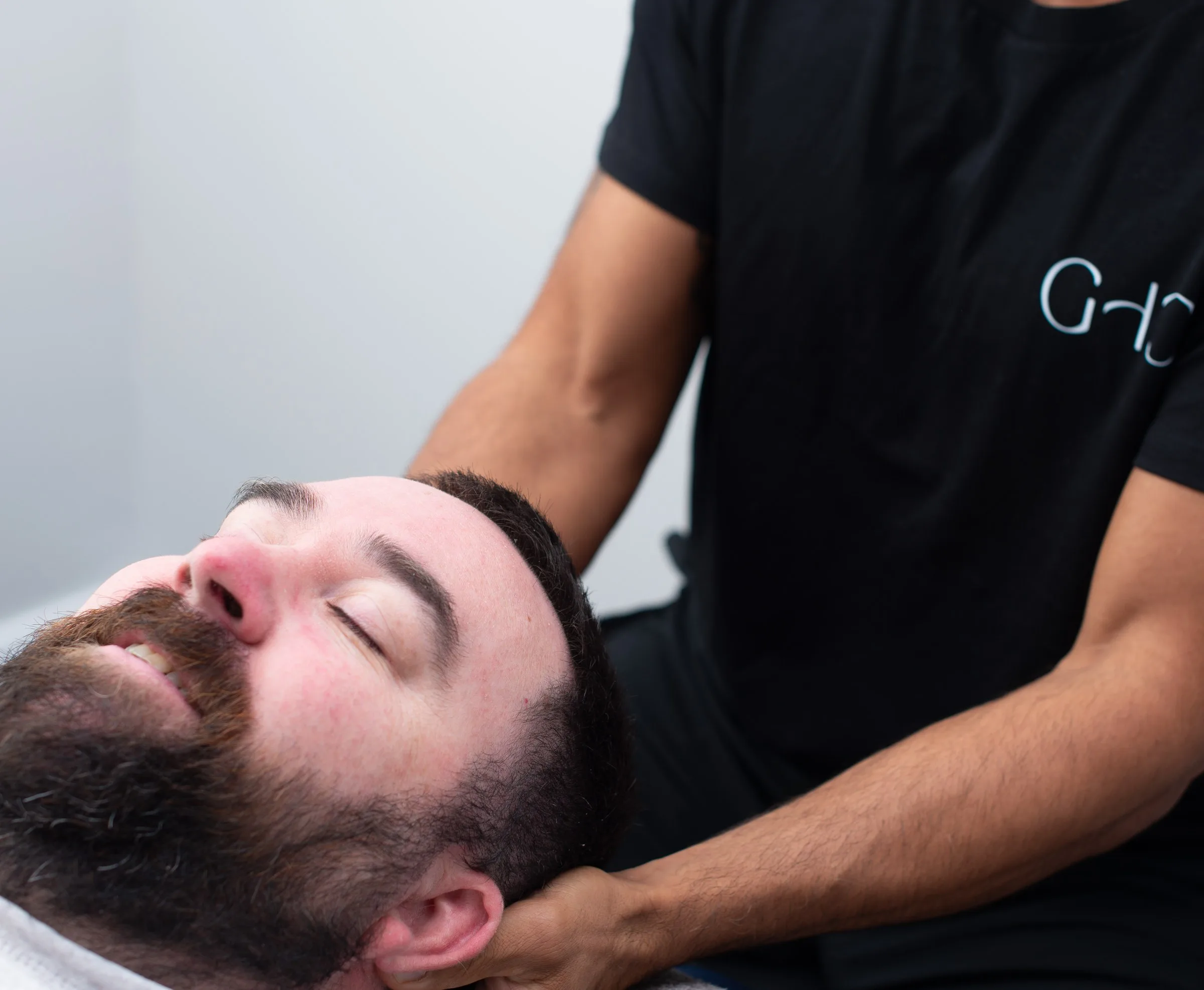 Chiropractor treating a patient on a treatment table