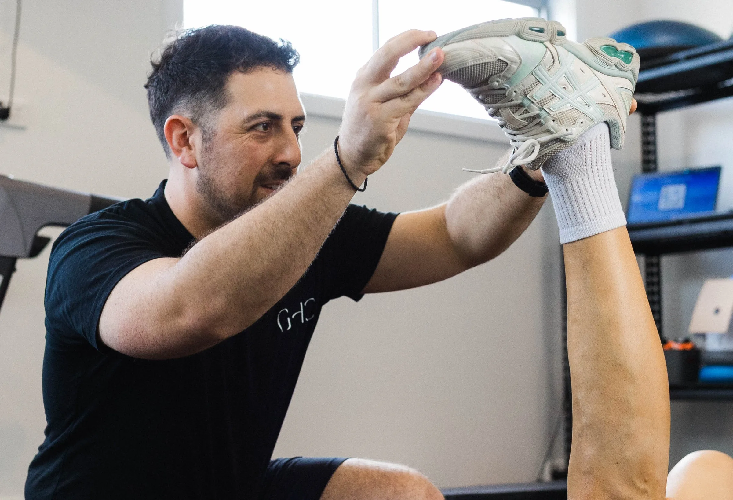 Podiatrist checking a patient's running shoe